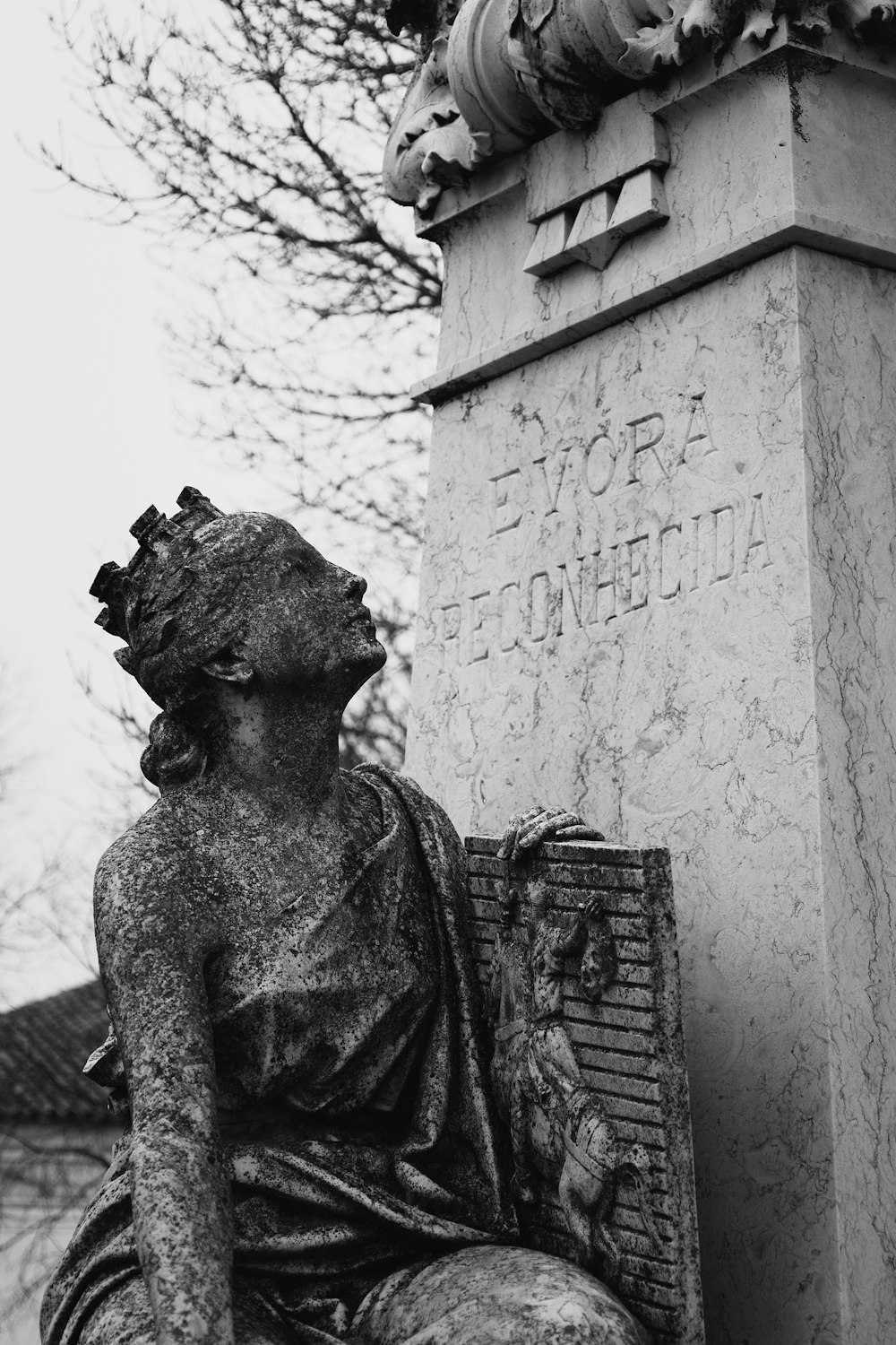 a statue of a woman sitting on a bench