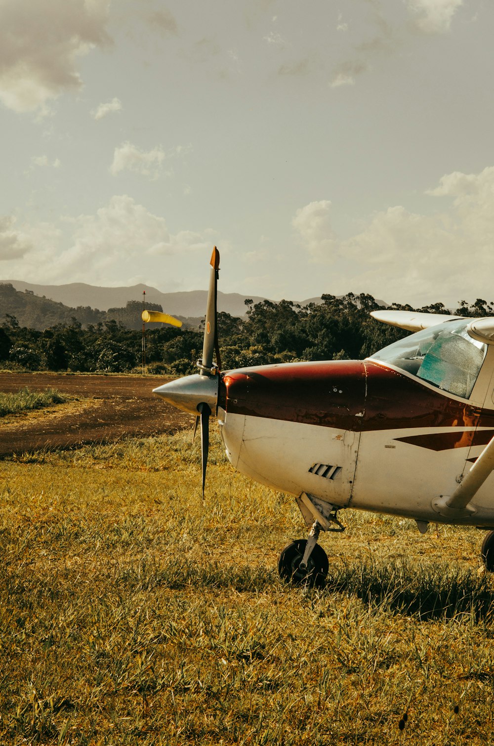 a small airplane sitting on top of a grass covered field