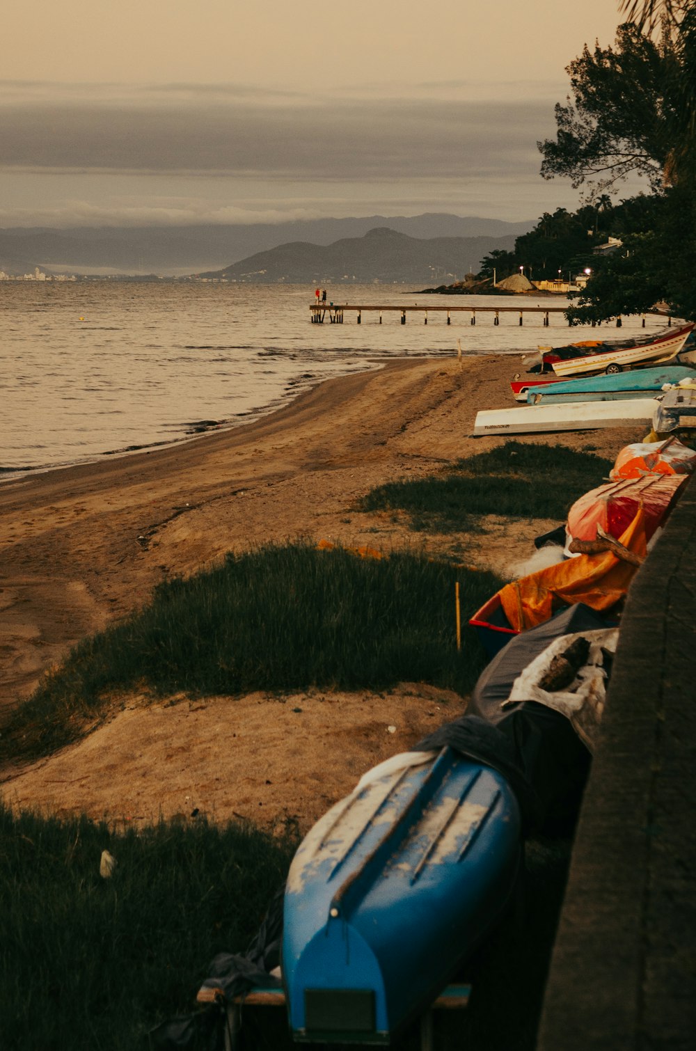 a row of boats sitting on top of a beach