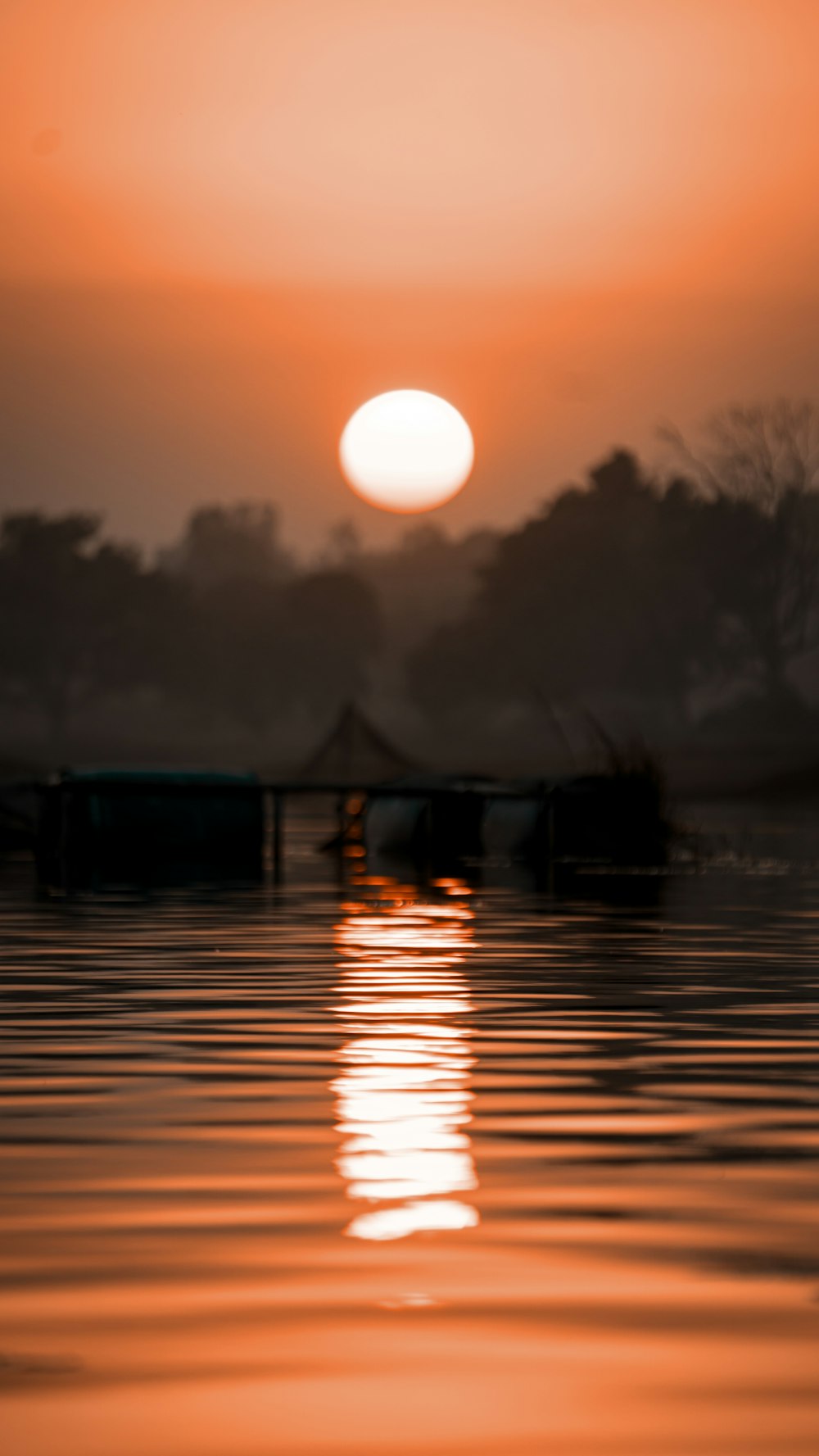 the sun is setting over a body of water