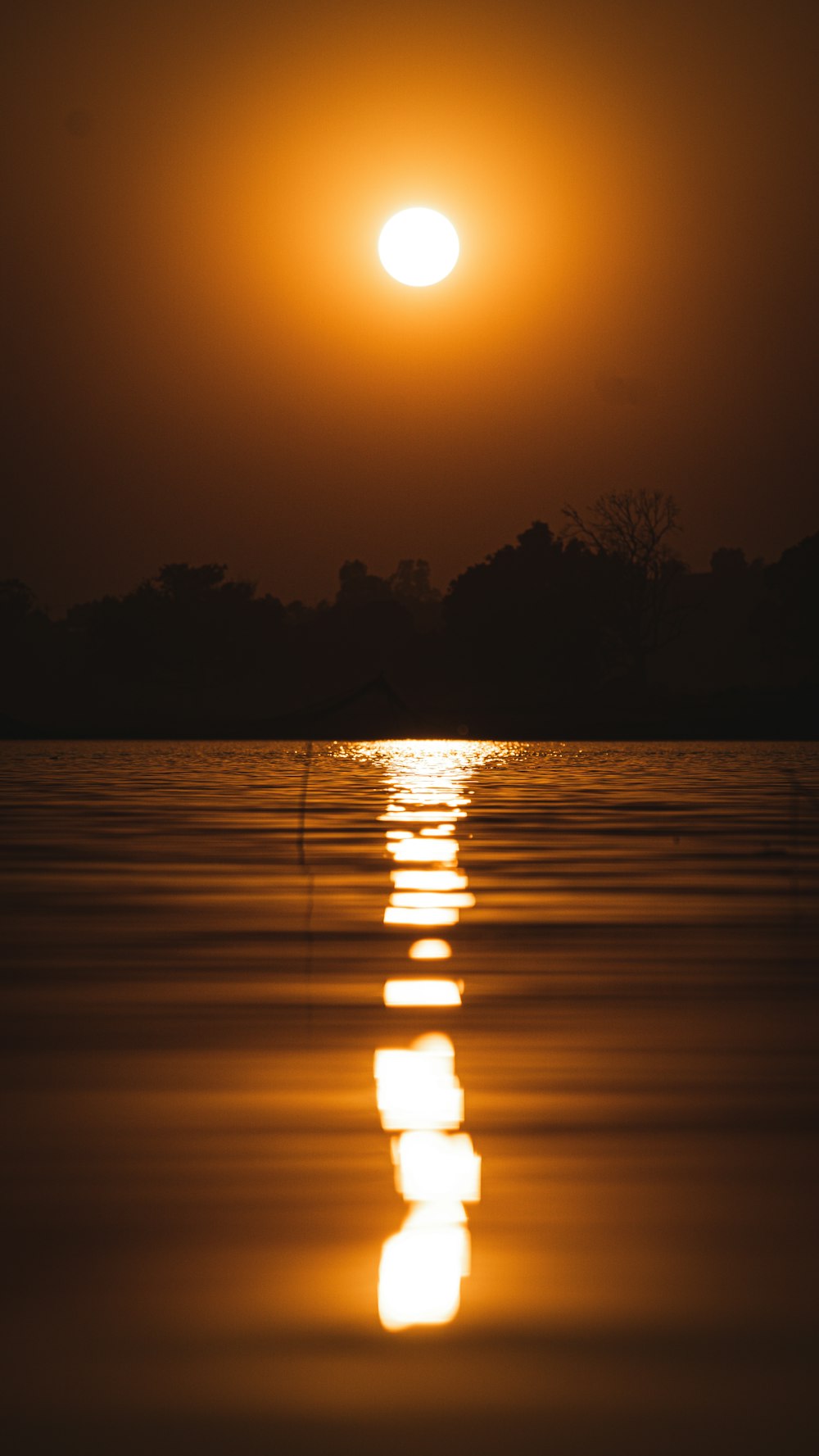 the sun is setting over a body of water