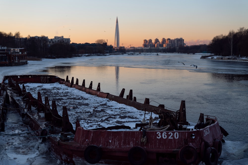 a boat sitting on top of a frozen river