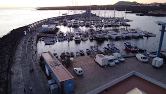 a harbor filled with lots of boats next to a bridge