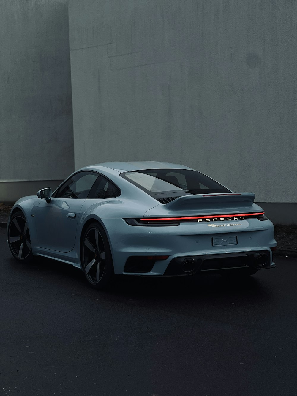 a grey sports car parked in a parking lot