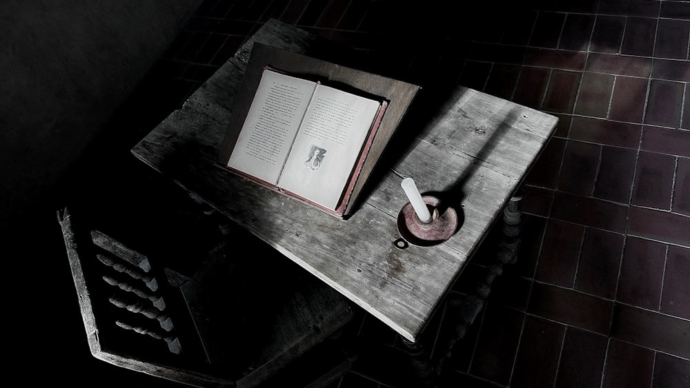 an open book sitting on top of a wooden table