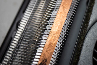 a close up of a metal object with a wooden surface
