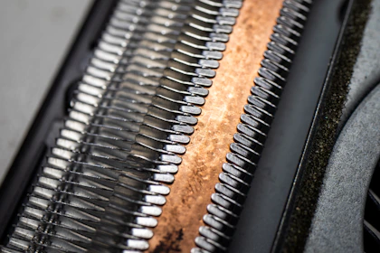 a close up of a metal object with a wooden surface