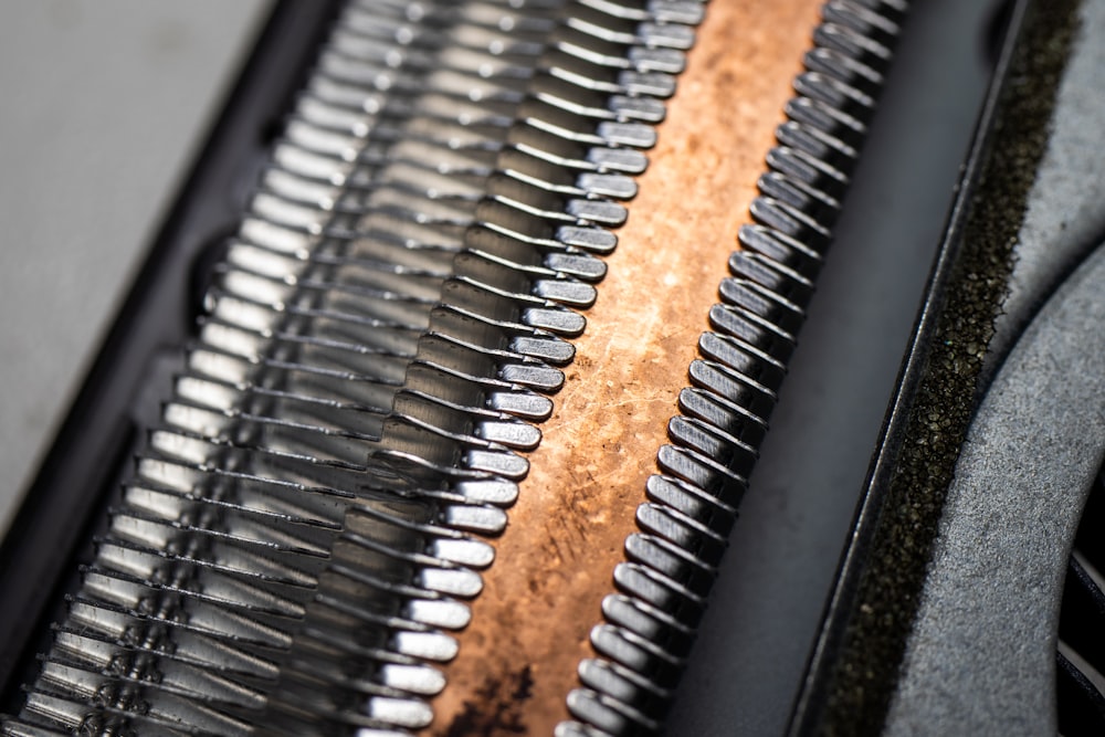 a close up of a metal object with a wooden surface