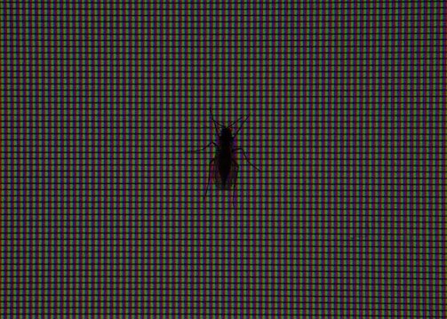 Close-up of a bug detector device in use during a sweep of a corporate meeting room.