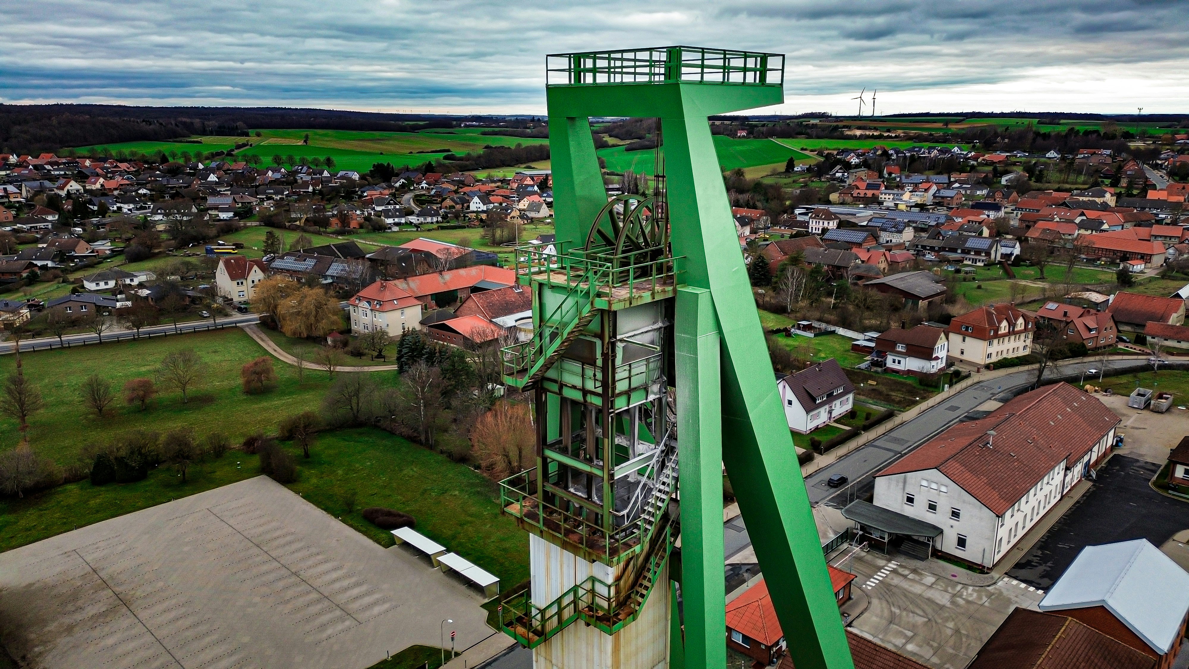 an aerial view of a green tower in a small town
