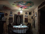 Cozy dining area with handcrafted wooden table and vibrant wall art.