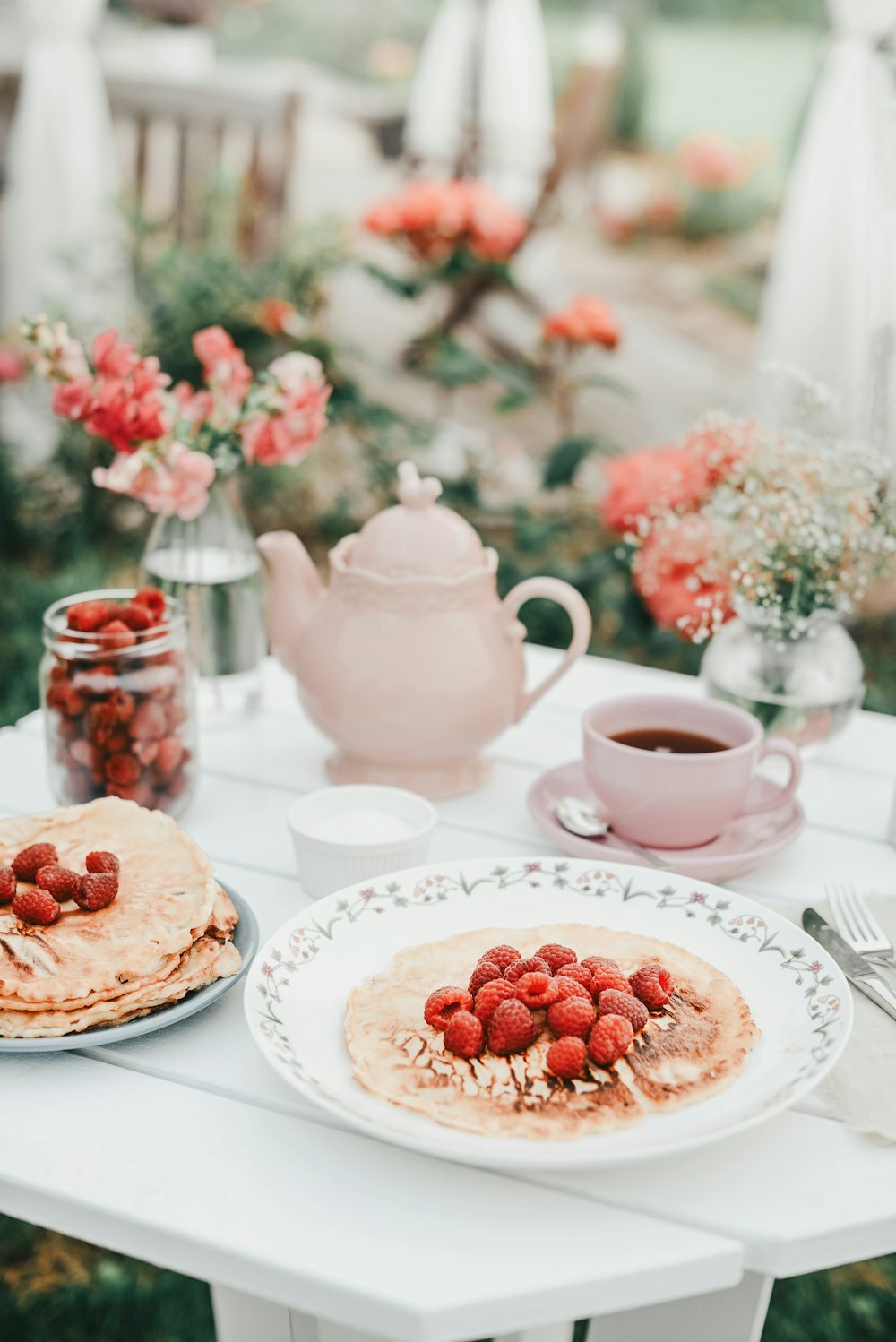 a white table topped with plates of food