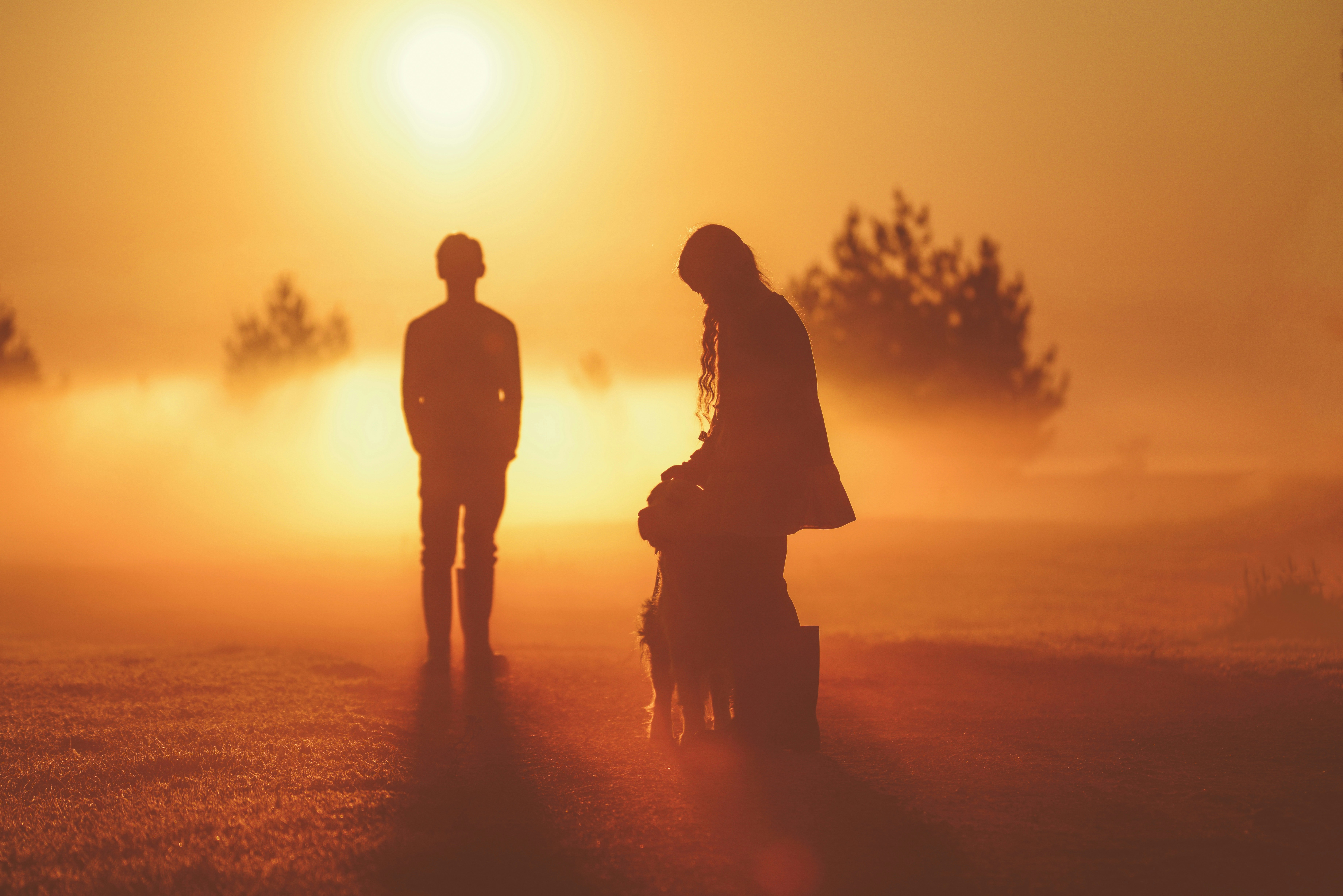a couple of people that are standing in the grass