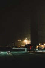Nighttime security guard patrolling a commercial property under soft lighting.
