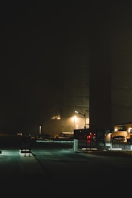 Nighttime security guard patrolling a commercial property under soft lighting.