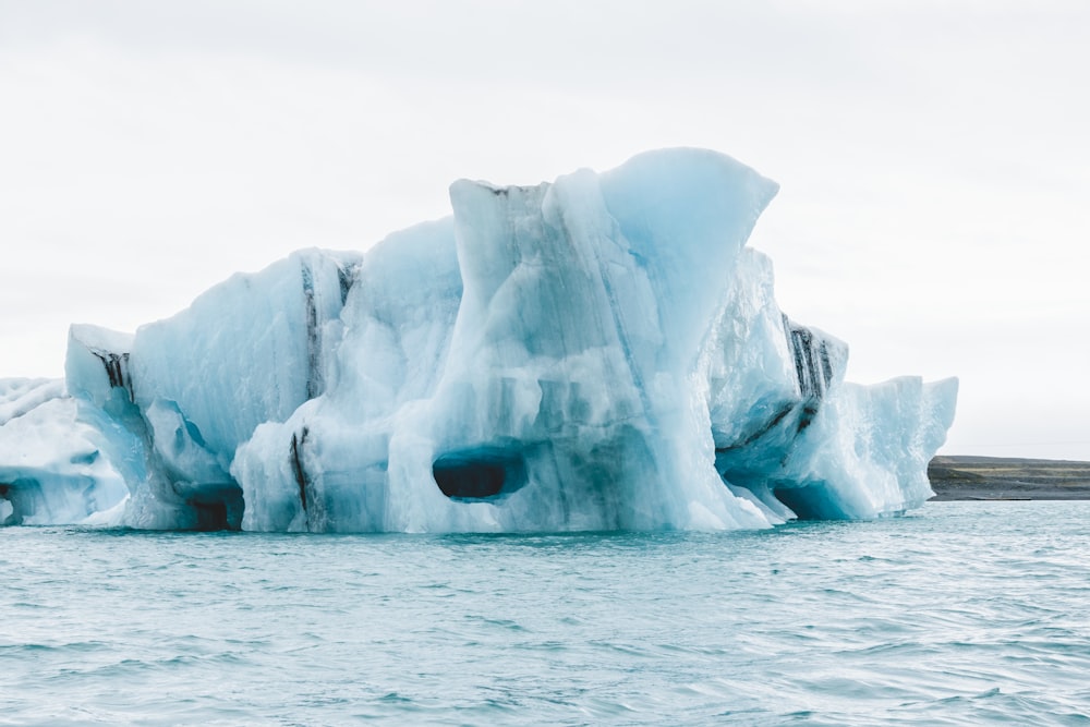 a large iceberg floating in the middle of the ocean