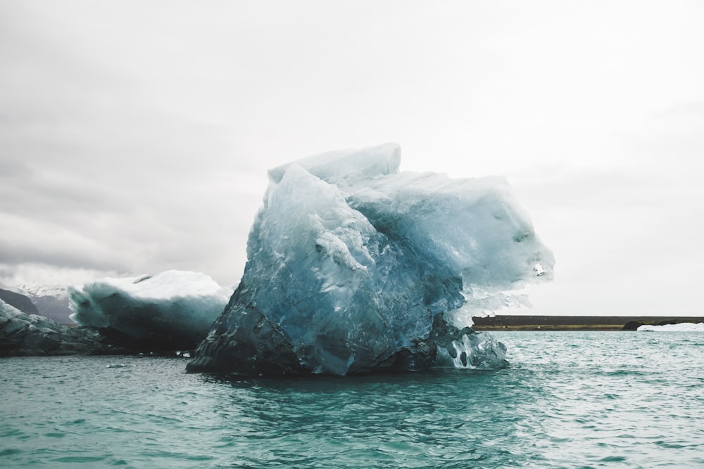 a large iceberg floating on top of a body of water