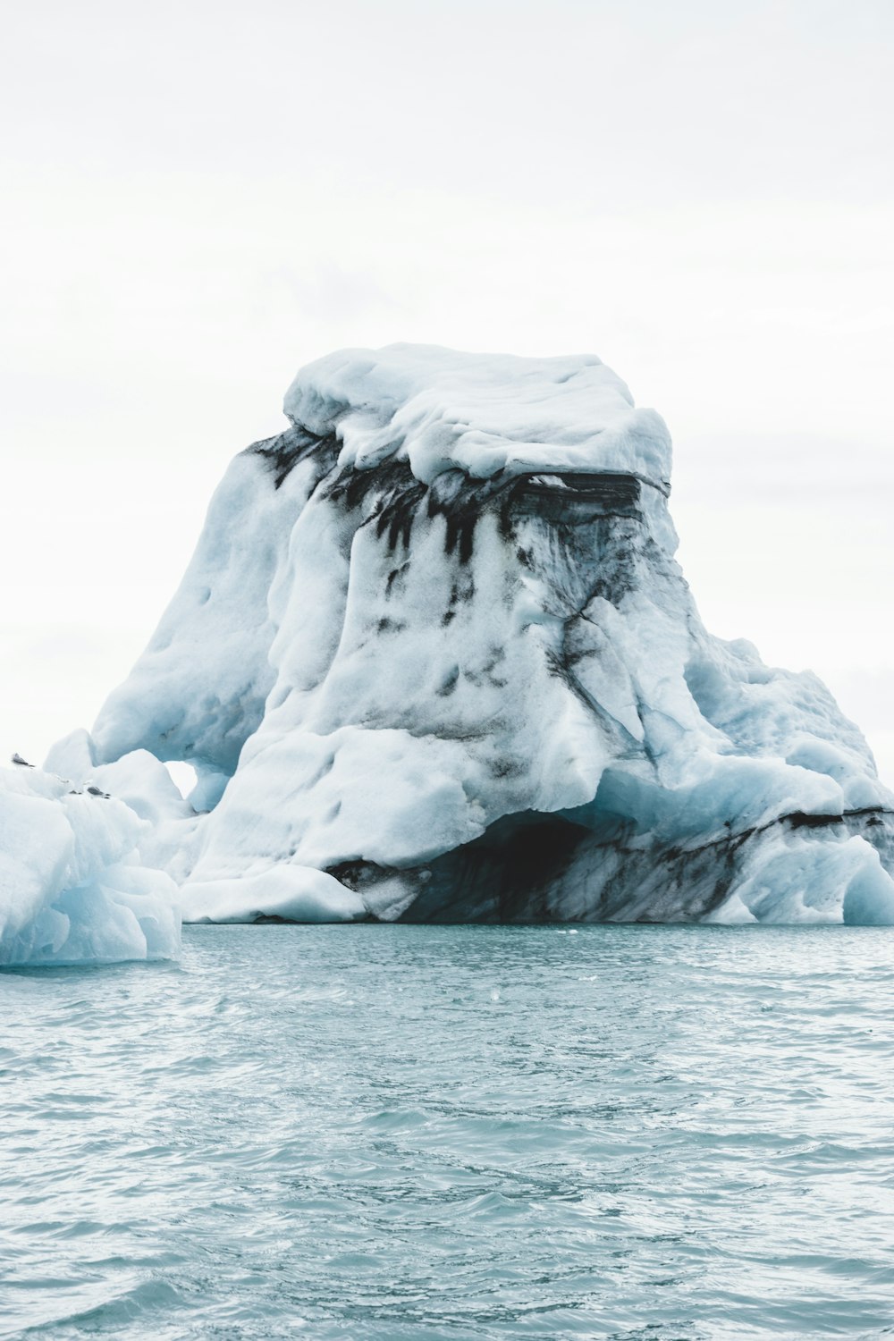 an iceberg in the middle of a body of water