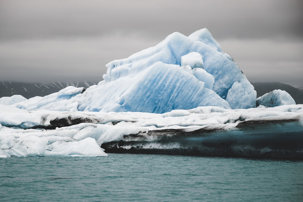 a large iceberg floating on top of a body of water