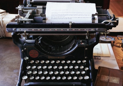 an old fashioned typewriter sitting on top of a table