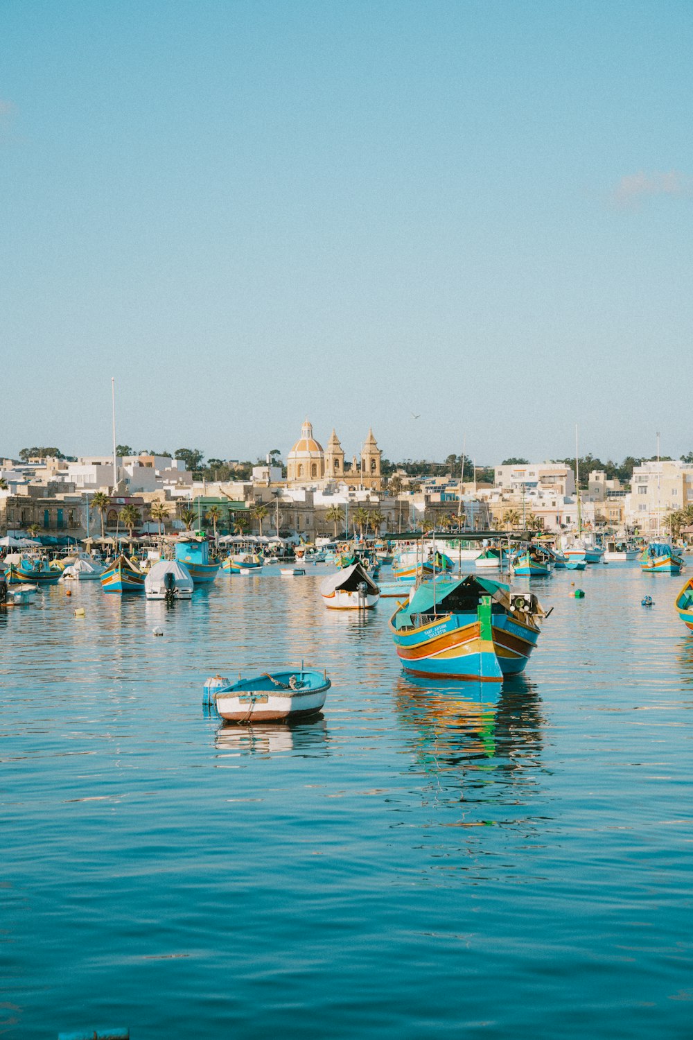 a group of boats floating on top of a body of water