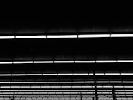 Rows of raised access flooring pedestals installed in a commercial building under bright lighting.