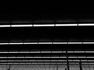 Rows of raised access flooring pedestals installed in a commercial building under bright lighting.