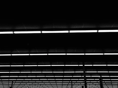 Rows of industrial-grade lighting fixtures neatly arranged in a warehouse setting.