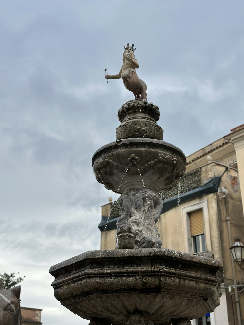 a statue of a horse on top of a fountain
