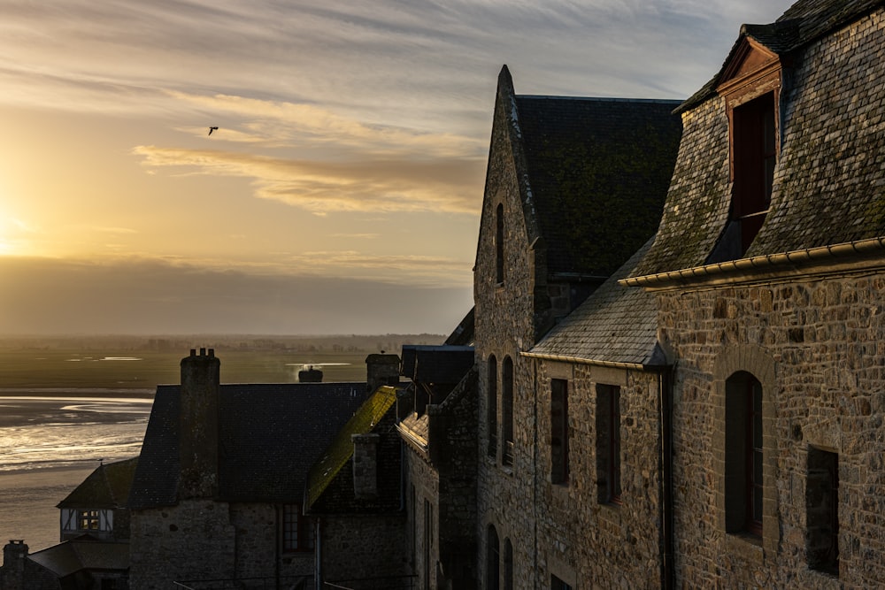 the sun is setting over a castle like building