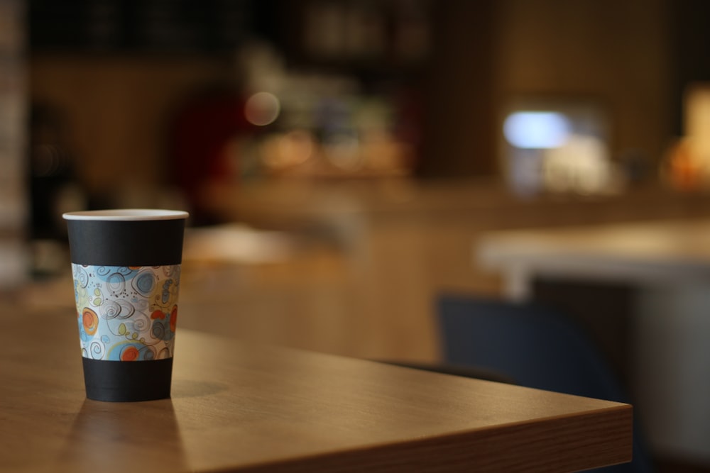 a coffee cup sitting on top of a wooden table