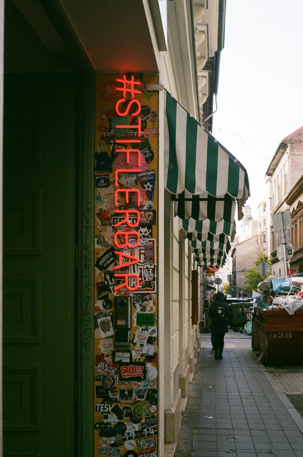 a store front with a neon sign on the side of it