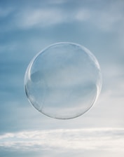 a clear bubble floating in the air on a cloudy day