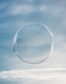 a clear bubble floating in the air on a cloudy day