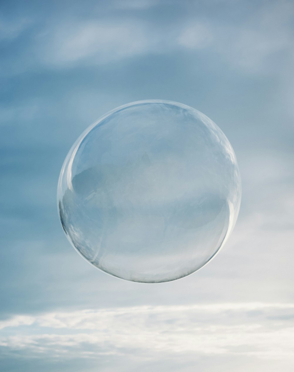 a clear bubble floating in the air on a cloudy day
