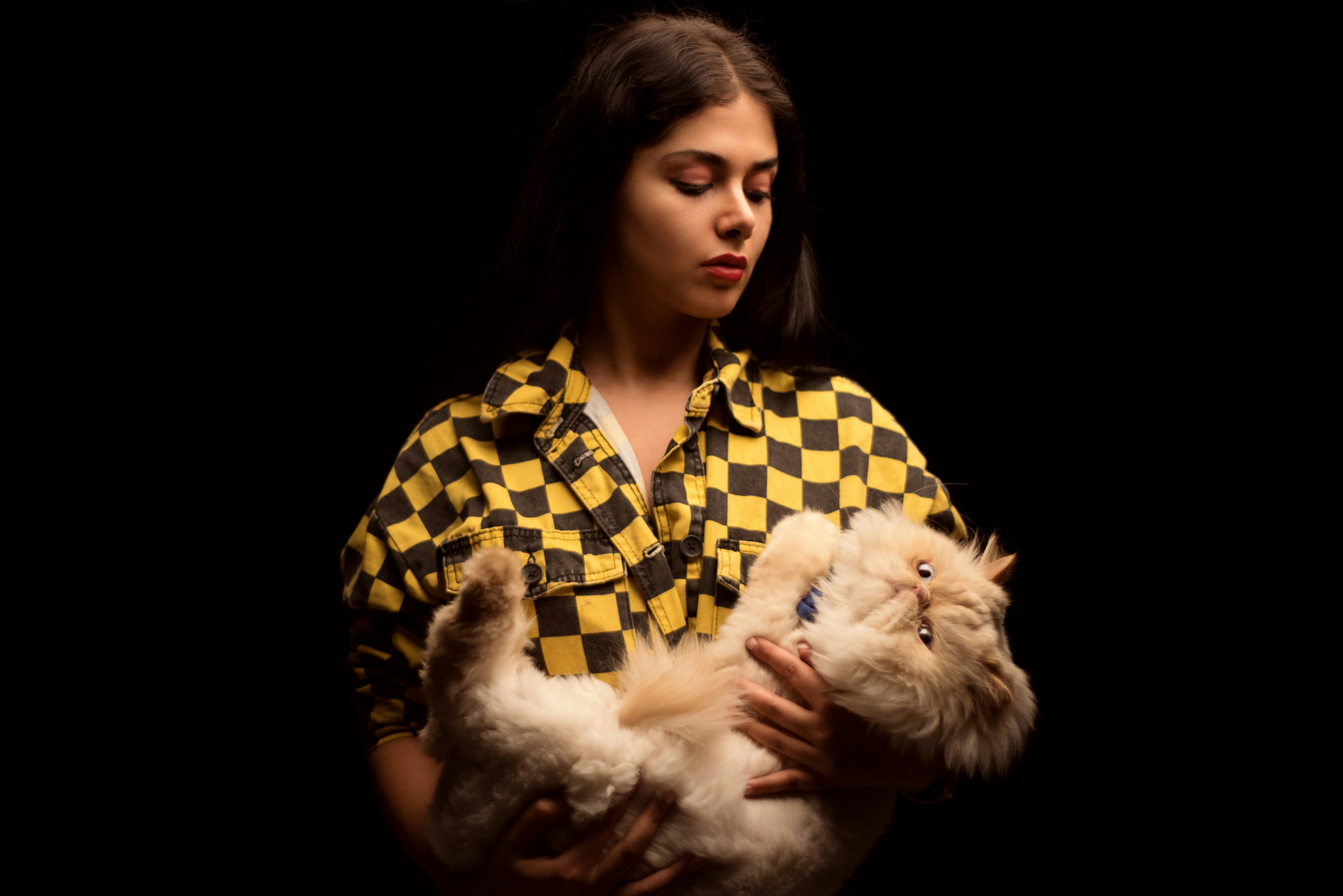 a woman holding a small dog in her arms