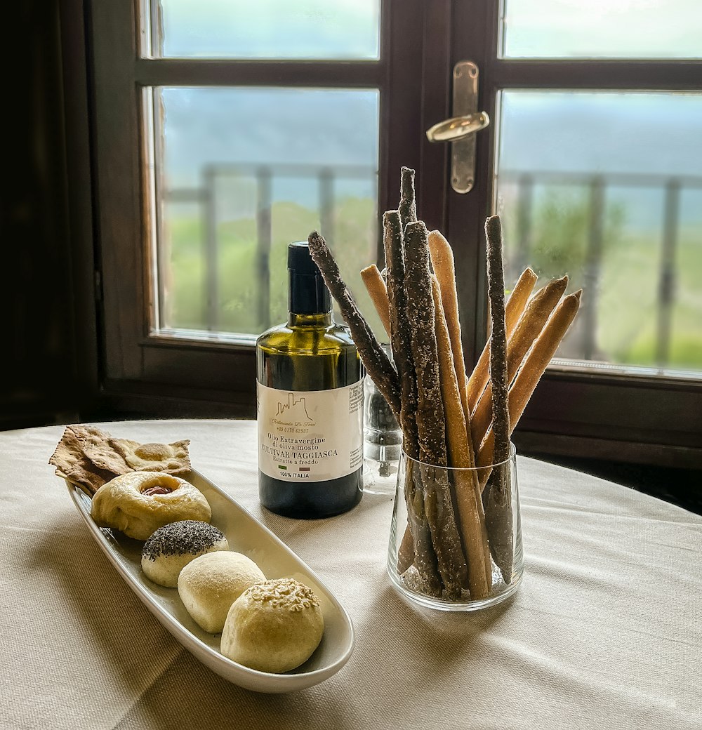 a table with a bottle of wine and a plate of food