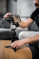 Close-up of hands adjusting the angle on a sleek zanazi llc selfie stick.