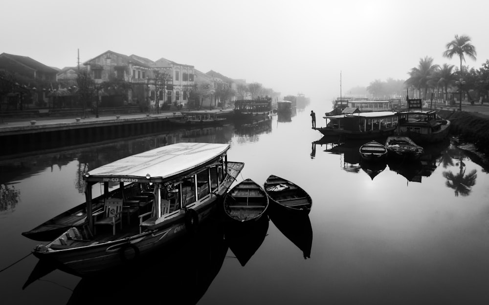 a group of boats floating on top of a river