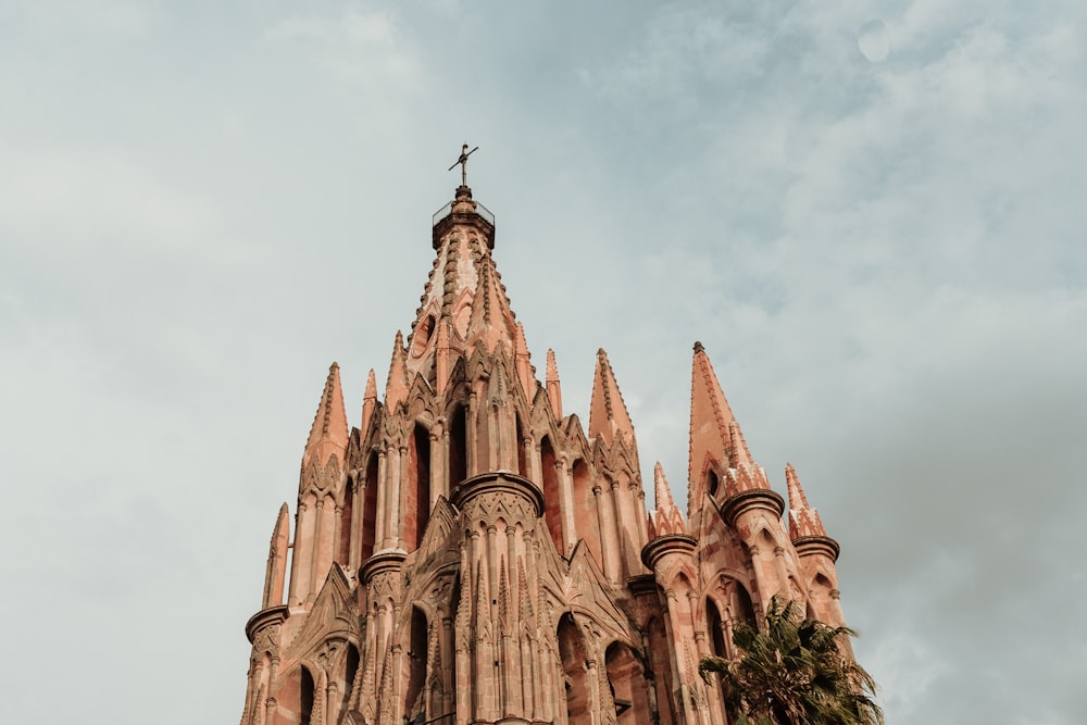 a tall building with a cross on top of it