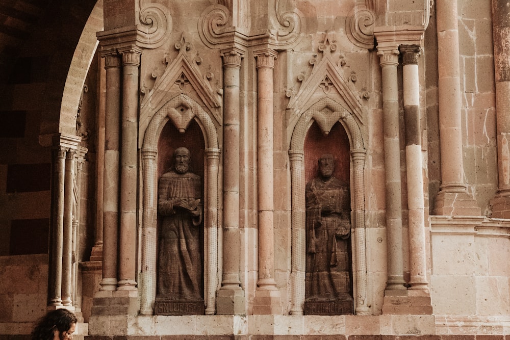 a statue of a man and a woman in front of a building