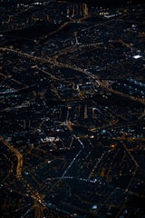 A dynamic nighttime aerial view of Quebec City with illuminated streets and landmarks.