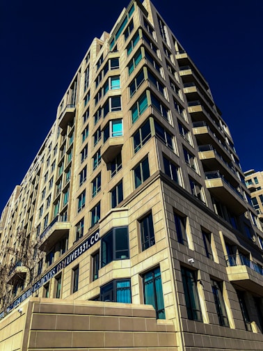 A modern apartment building with auction banners hanging from balconies.