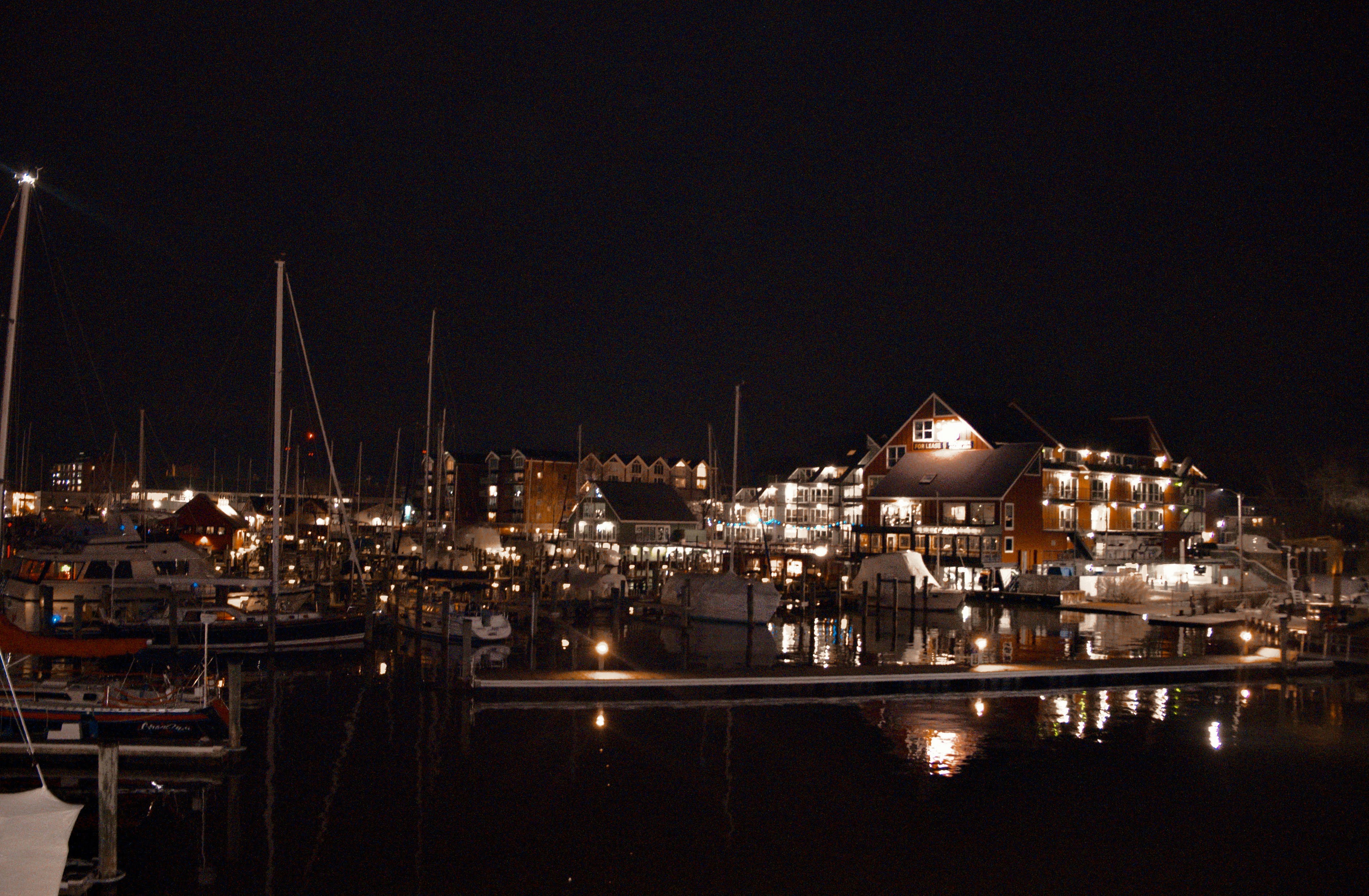a harbor filled with lots of boats at night, 