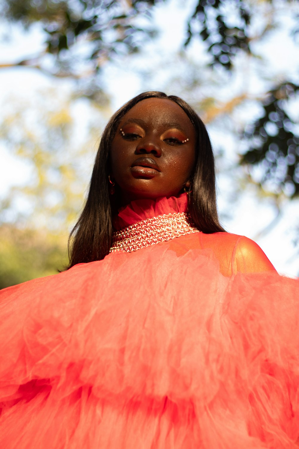 a woman in an orange dress with a red dress on