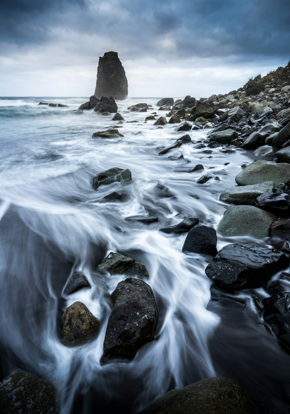 Una foto de larga exposición de una playa rocosa