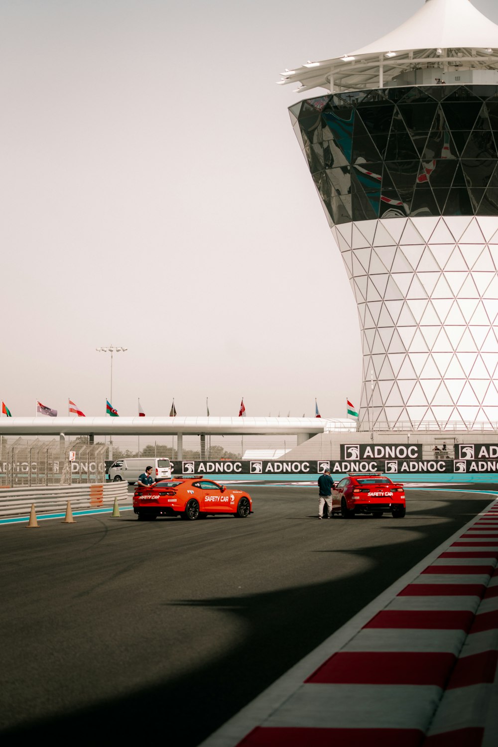 a group of cars driving down a race track