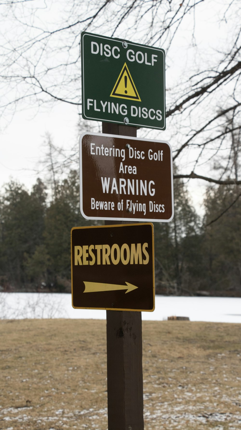 a wooden pole with several signs on top of it