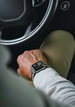 A happy car owner receiving a weekly payment notification on their phone.