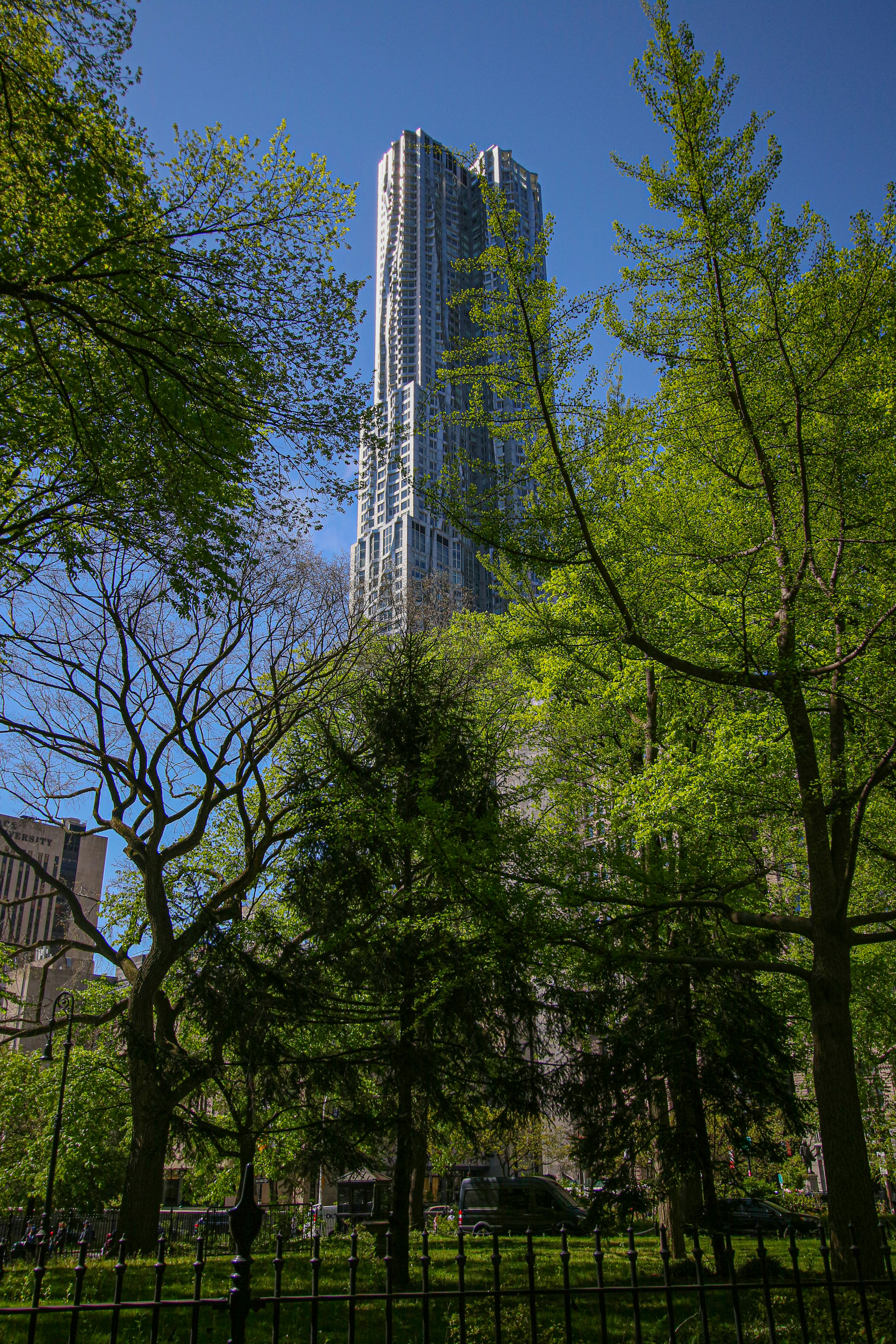 a tall building surrounded by trees in a park